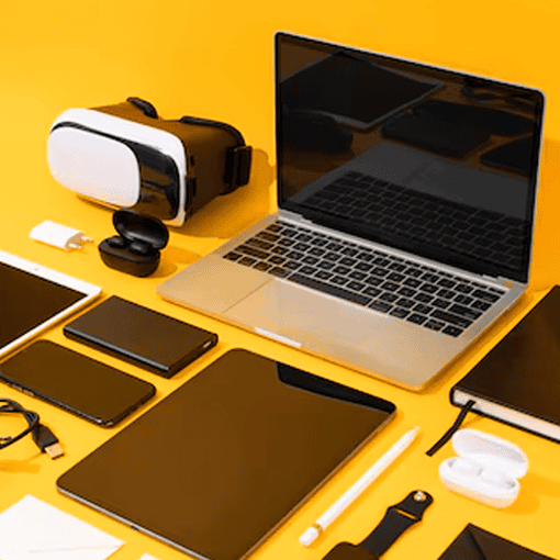 VR headset, laptops, tablets, smartphones, and accessories on a yellow background, modern tech gadgets for entertainment and work.