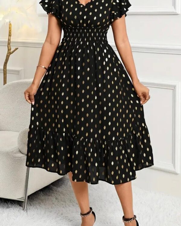 Vestido longo preto com poás dourados, perfeito para ocasiões especiais e elegantes.